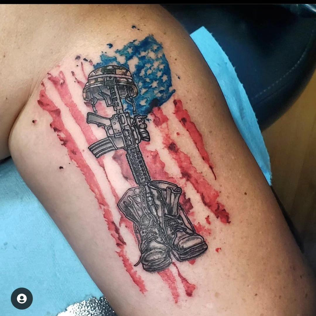 American flag color tattoo with military boots, gun and helmet.